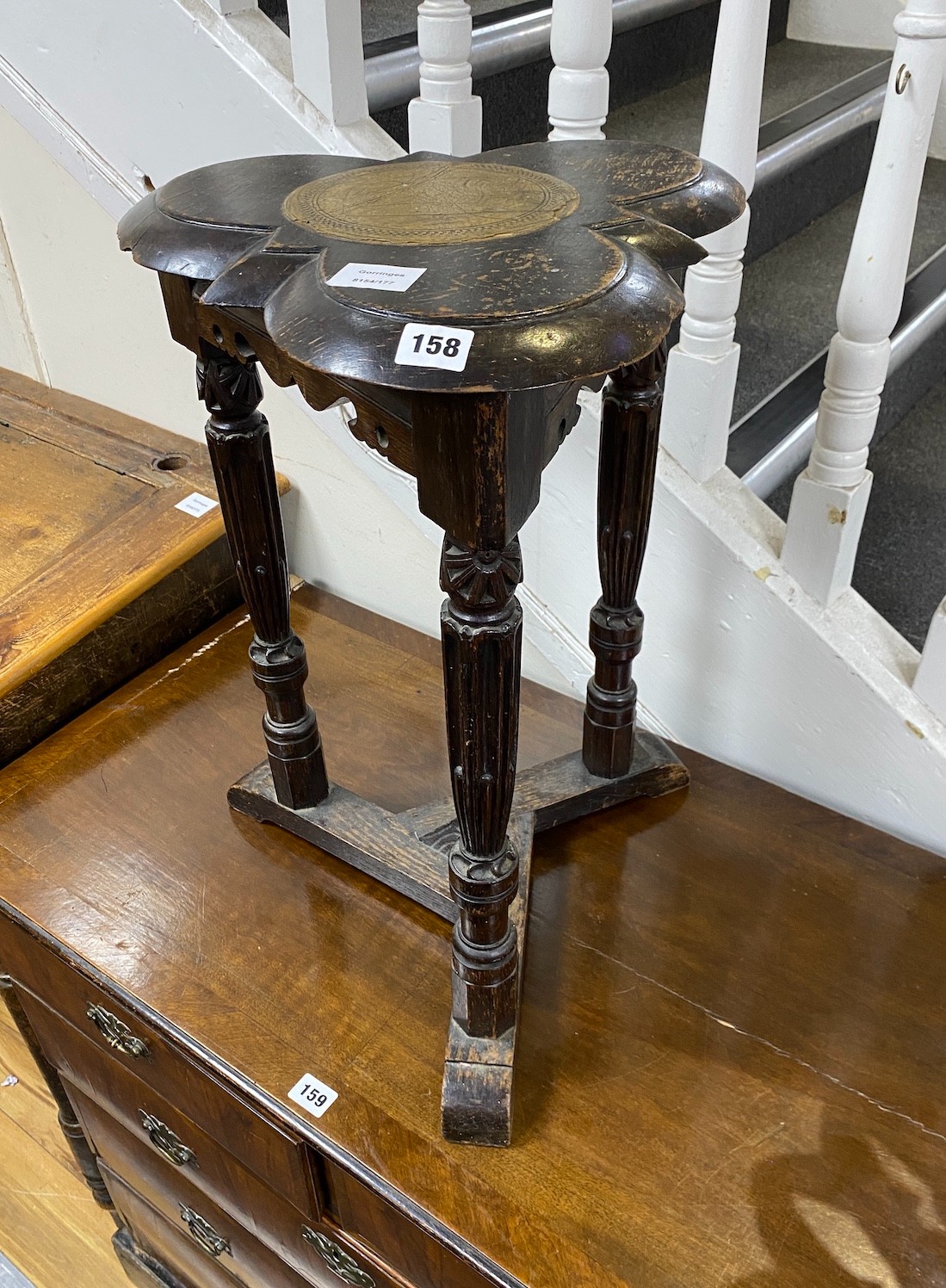 An unusual carved oak trefoil occasional table, width 36cm, height 58cm